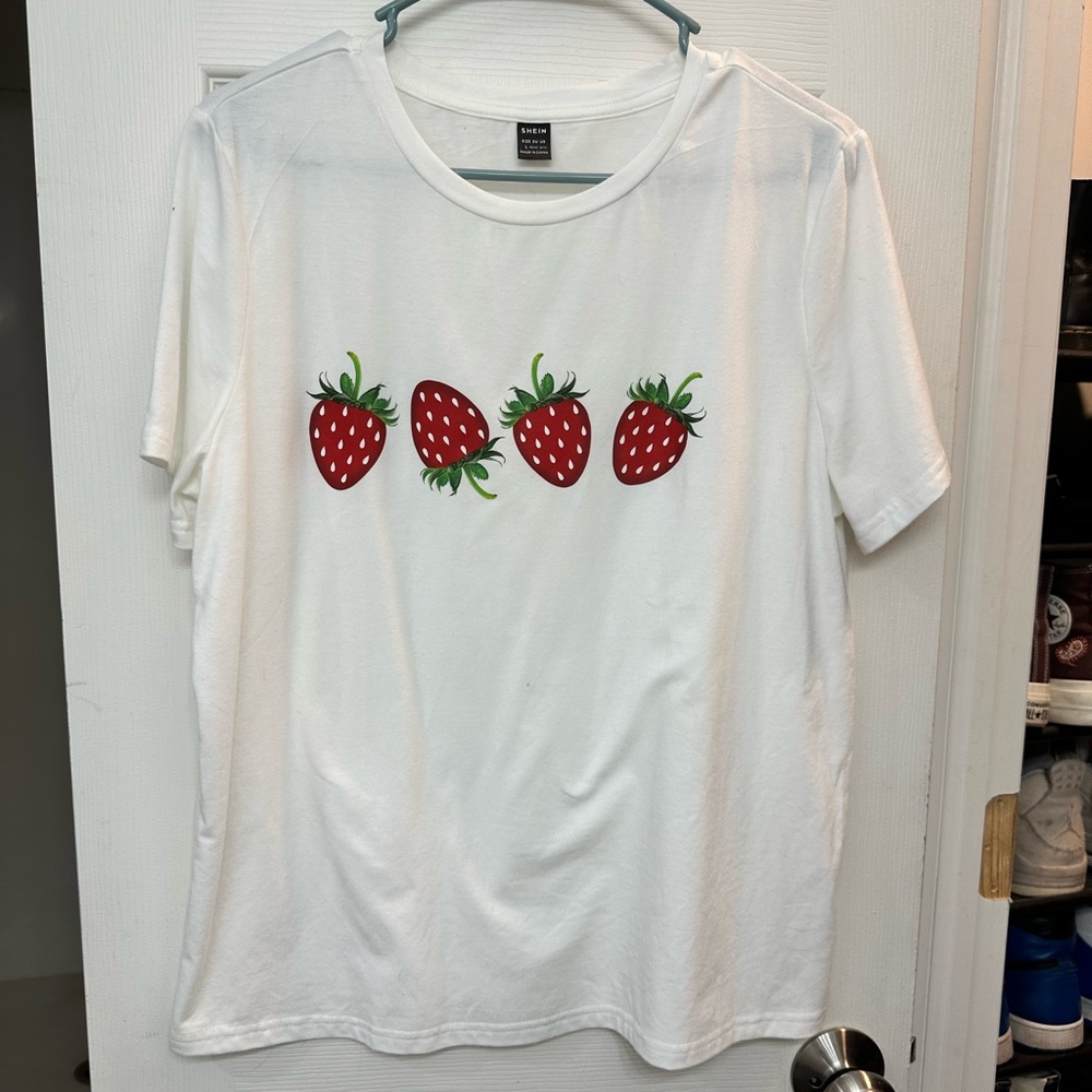 Large white shirt with strawberries that has never been worn